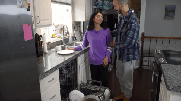 A still from Understanding Pregnancy 2nd Edition Video Program showing a pregnant couple doing dishes together.