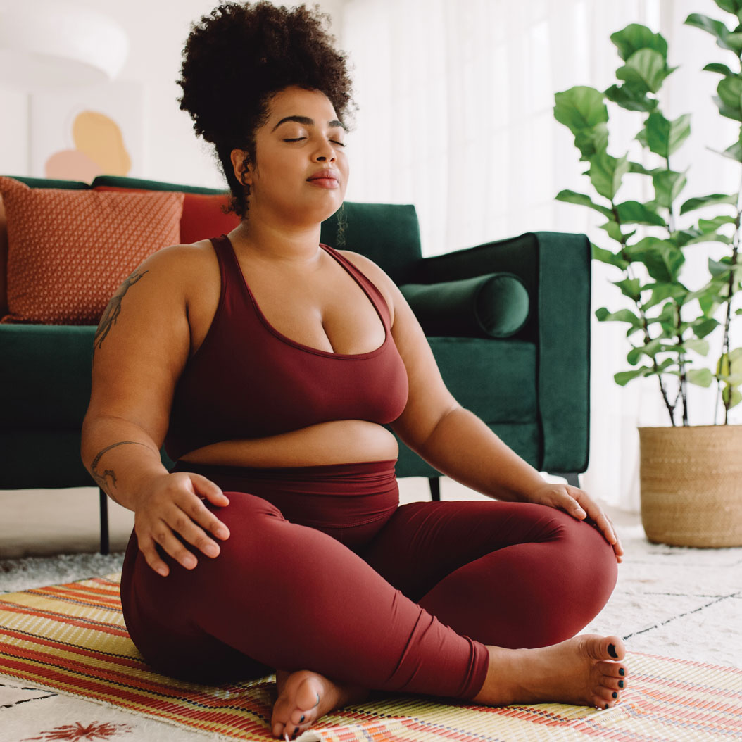 Woman sitting on the floor meditating