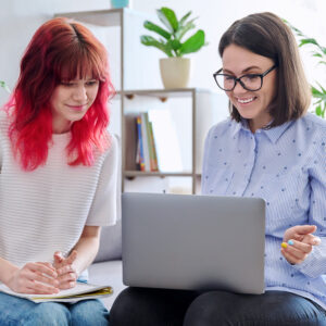 pregnancy center educator showing educational videos to teen mom in early pregnancy