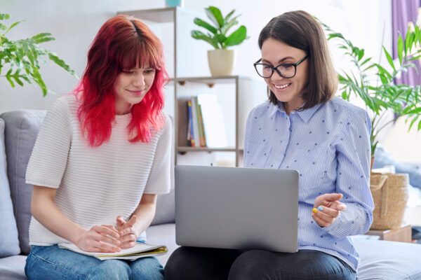 pregnancy center educator showing educational videos to teen mom in early pregnancy