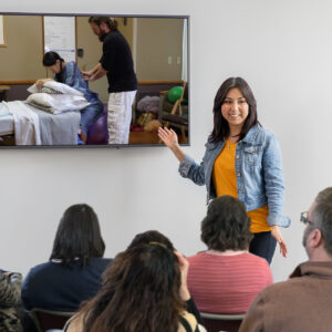 An independent childbirth educator using the Natural Birth & Beyond Video Library to show her childbirth class parents a video of labor pain management.