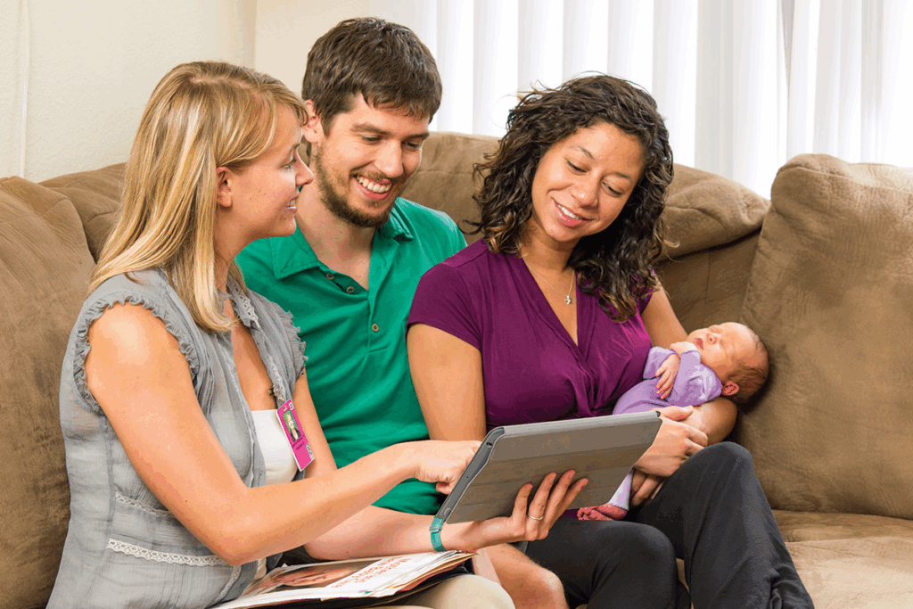 Home Visitation nurse with new parents and their newborn.